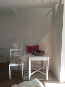 a table and a chair in a room with a staircase at ihle-huimat in Oberstdorf