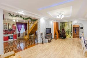 a living room with a staircase and a christmas tree at Северная Звезда in Saint Petersburg