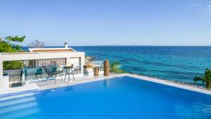 a swimming pool with a view of the ocean at Nerea SeaFront Villa, a Pristine Retreat, By ThinkVilla in Akrotiri