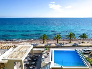 a view of the ocean from a house with a swimming pool at Nerea SeaFront Villa, a Pristine Retreat, By ThinkVilla in Akrotiri