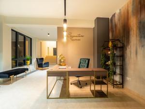 an office with a desk and chairs in a room at Signature Aparthotel - Boutique in Galaţi