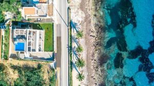 an aerial view of a beach and the ocean at Nerea SeaFront Villa, a Pristine Retreat, By ThinkVilla in Akrotiri