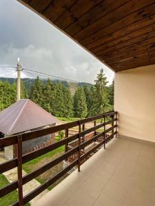 a balcony of a house with a view of the mountains at Cabana Izvorul Ariesului in Vartop