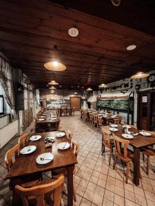 a large dining room with wooden tables and chairs at Penzion Na Vošverku in Čelákovice