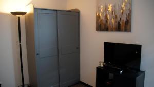 a bedroom with a large cabinet and a television at Impasse 2 in Fosses-La-Ville