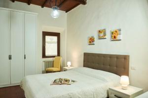 a bedroom with a bed with a book on it at Casa Lavanda Panzano in Chianti in Greve in Chianti
