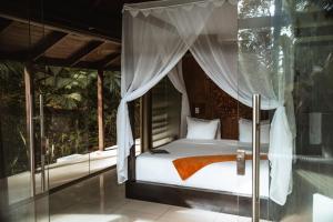 a bed in a room with a window at Oxygen Jungle Villas & Spa in Uvita +123 photos