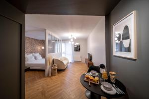 a living room with a bed and a table at Suite Georgia - Check in h24 - Wifi in Villeurbanne