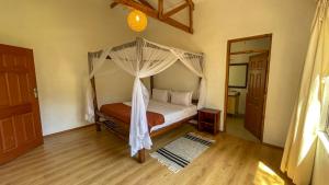 a bedroom with a bed with a canopy at The Senna House in Nakuru