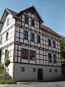 a large white and black building with windows at Minicamping und B&B Apartment Hintergarten in Niederorschel
