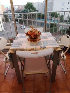 a table on a balcony with a bowl of food on it at Studio Cap d'Agde le Môle in Cap d'Agde