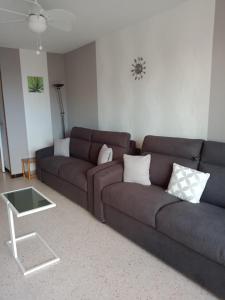 a living room with a couch and a coffee table at Studio Cap d'Agde le Môle in Cap d'Agde