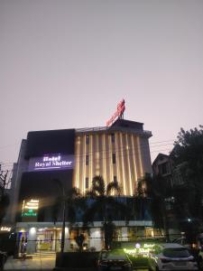 a building with a crane on top of it at Hotel Royal Shelter in Vapi
