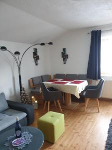 a living room with a table and chairs at Haus Guem in Ehrwald