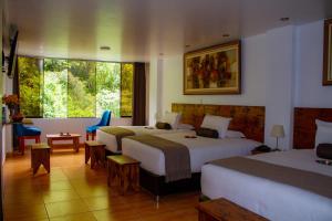 a hotel room with two beds and a window at Hotel Tara Machupicchu in Machu Picchu +79 photos