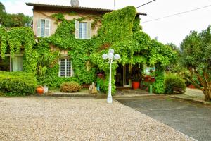 a house with a street light in front of it at Hotel La Culla Del Lago in Castel Gandolfo