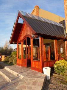 a small house with a solar roof on it at Hosteria Posta Sur in El Calafate