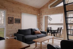 a living room with a couch and a table at Villa Korppi in Jorvas
