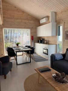 a living room with a table and a kitchen at Villa Korppi in Jorvas +16 photos