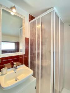 a bathroom with a sink and a shower at Casa Bucaneve & Ciclamino in Gravedona +46 photos