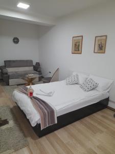 um quarto com uma cama e um sofá em Sleep and drive No1 em Sarajevo
