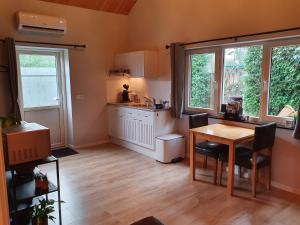 a kitchen with a table and chairs and windows at Stay America in America