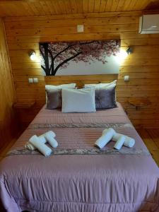 a bedroom with a bed with two pillows on it at Quinta do Pinheiro in Grândola