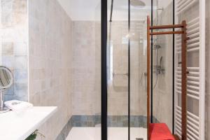 a bathroom with a shower and a sink at La Little Maison in Loches