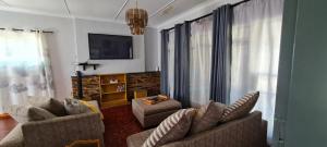 a living room with two chairs and a tv at Casa Bianco: Affordable luxury - Self Catering House in Parys