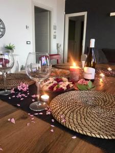 a table with wine glasses and a bottle of wine at Villa Paradiso in Campofilone