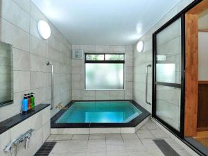 uma casa de banho com uma piscina e um chuveiro em Ryokan Seifuso - Vacation STAY 02201v em Matsumoto