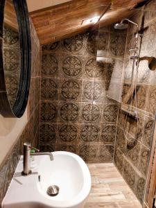 a bathroom with a sink and a shower at Trawden Arms Community Owned Pub in Winewall