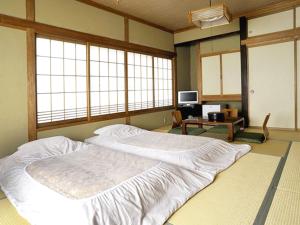 Ένα ή περισσότερα κρεβάτια σε δωμάτιο στο Ryokan Seifuso - Vacation STAY 02208v