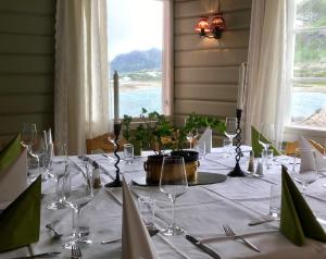 a table with a white table cloth and wine glasses at Jotunheimen Arctic Domes in Beitostøl