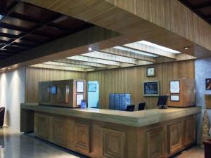 a lobby with a reception desk in a building at Corinto Hotel in Mexico City