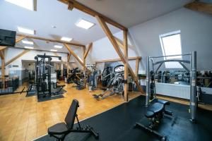 a gym with several treadmills and exercise bikes at MyApartment in Râşnov