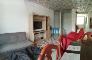 sala de estar con sofá, mesa y sillas en Apartamento Iwoo Hr, en Villavicencio