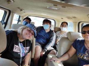 a group of people in a van wearing masks at Hostal LAS GARZAS DEL PELADO in Playas
