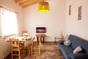 a living room with a blue couch and a table at Quinta das Aguas in Aljezur +39 photos