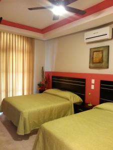 
a hotel room with two beds and two lamps at Hotel y Suites Los Encantos in Sayulita

