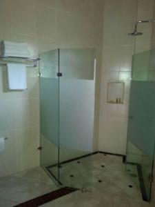 a bathroom with a shower stall and a toilet at Hotel y Suites Los Encantos in Sayulita