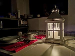 a table with plates and a lantern on a table at Martin´s House in Martin