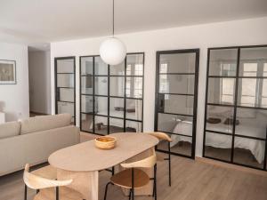 a living room with a table and a couch at L'ORANGERAIE Appartement design en plein centre in Castres