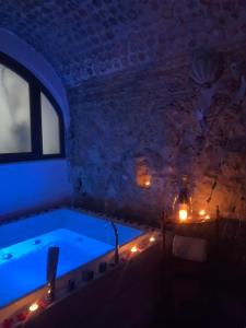a bathroom with a tub with lights in it at Casa Angelieri in Pizzo