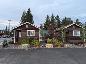a couple of small houses in a parking lot at 9 Bar W Cabins in West Yellowstone