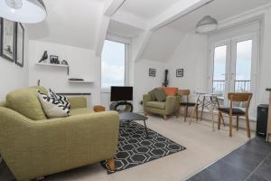 a living room with a couch and chairs and a table at Headland Apt 17 in Coverack