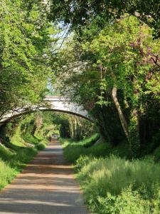 a road with an archway in the middle at Le Lude Land Musée in Le Lude +1 photo