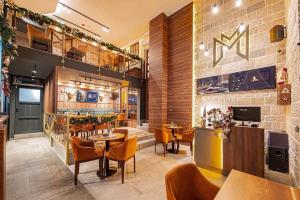 a restaurant with tables and chairs and a bar at Modern mountain - Crown apartment in Kolašin