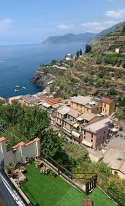 a small town on a hill next to the ocean at Orizzonti Apartments in Manarola