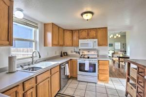 a kitchen with wooden cabinets and white appliances at 1/2 Mi to Tennyson: Pet-Friendly Denver Gem in Denver +24 photos